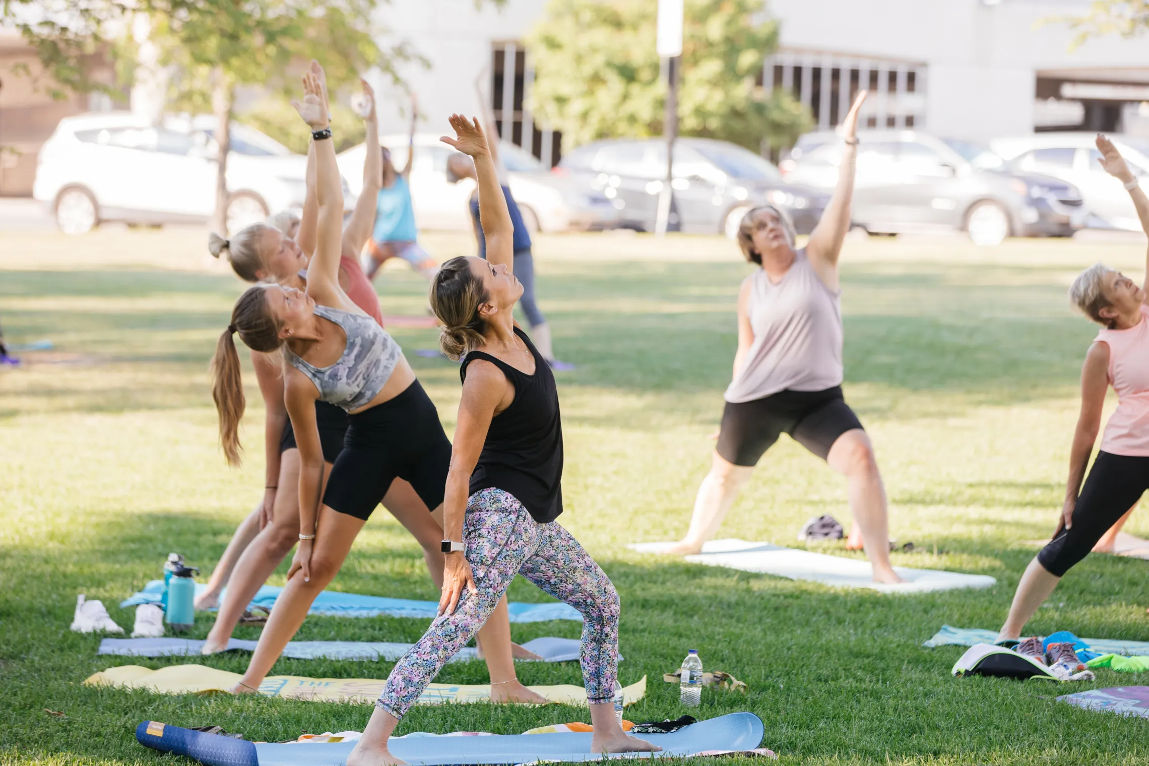 Women doing yoga in a park.